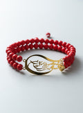 Gold-plated Persian calligraphy bracelet with red stone beads on white