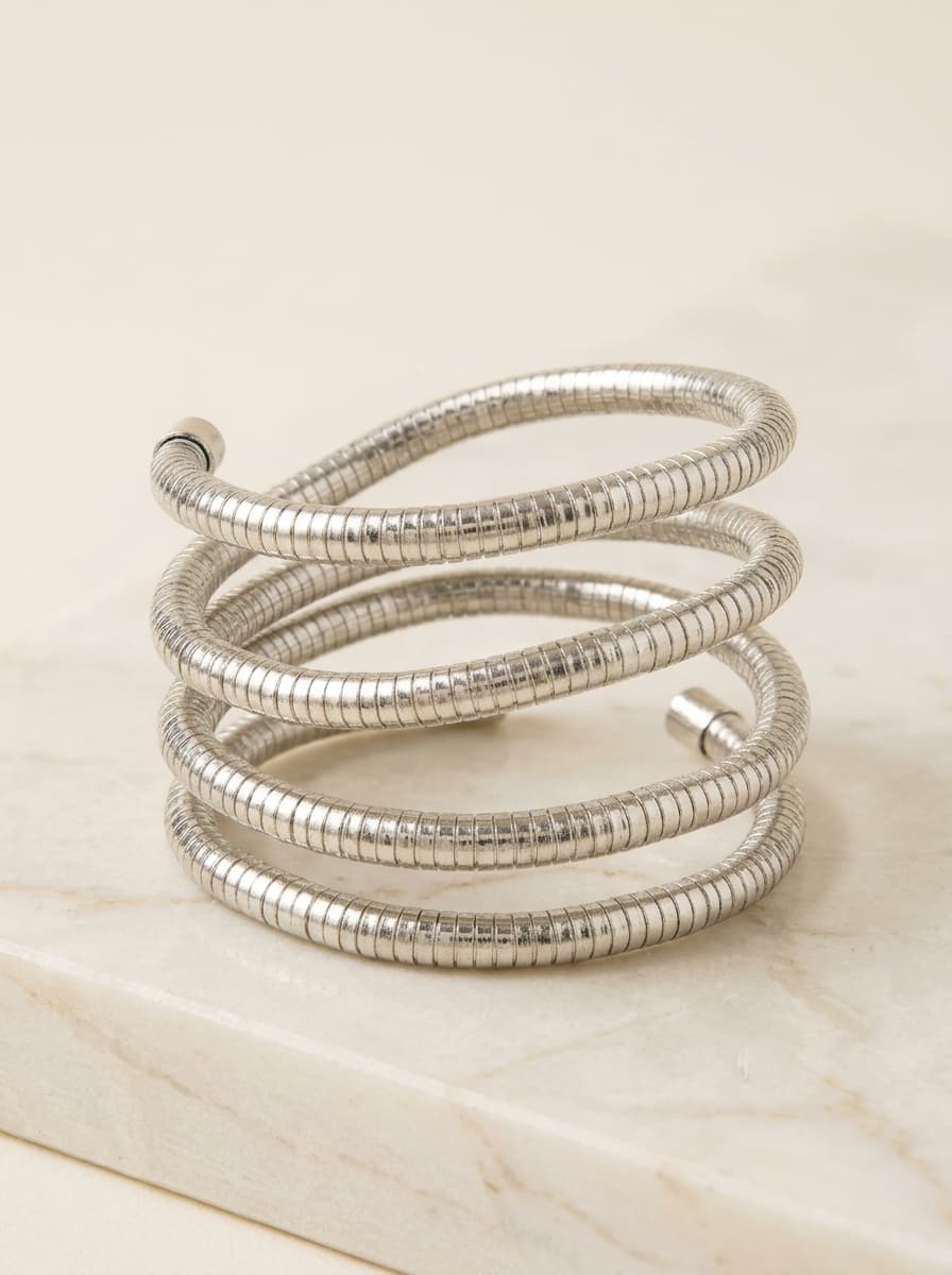 Silver-tone snake chain spiral coil wrap bracelet on marble