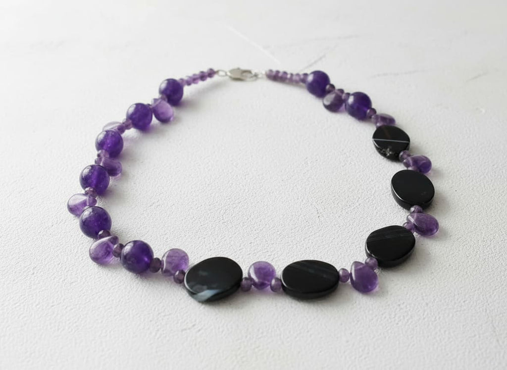 Pure amethyst necklace with black oval stones on white