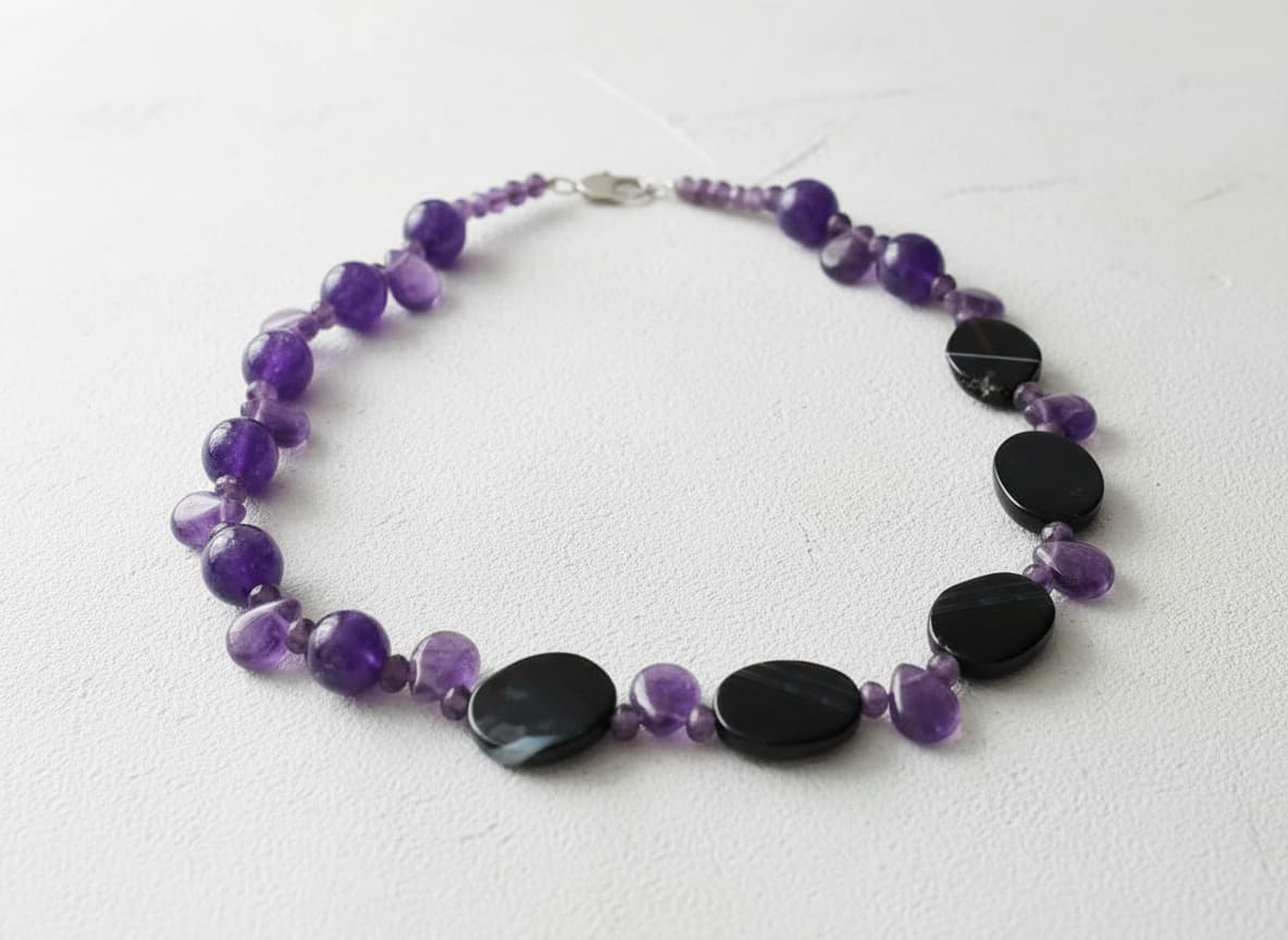 Pure amethyst necklace with black oval stones on white