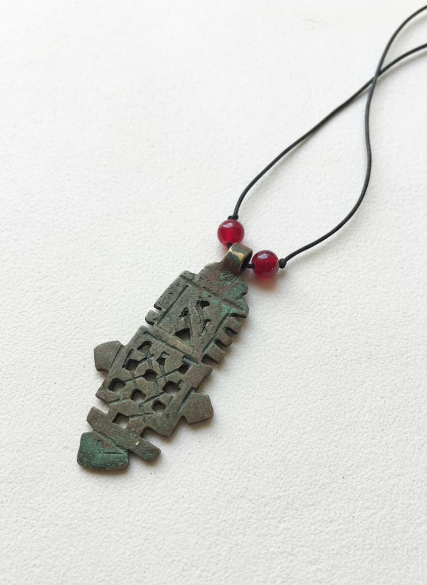 Brass-plated antique art pendant necklace on white
