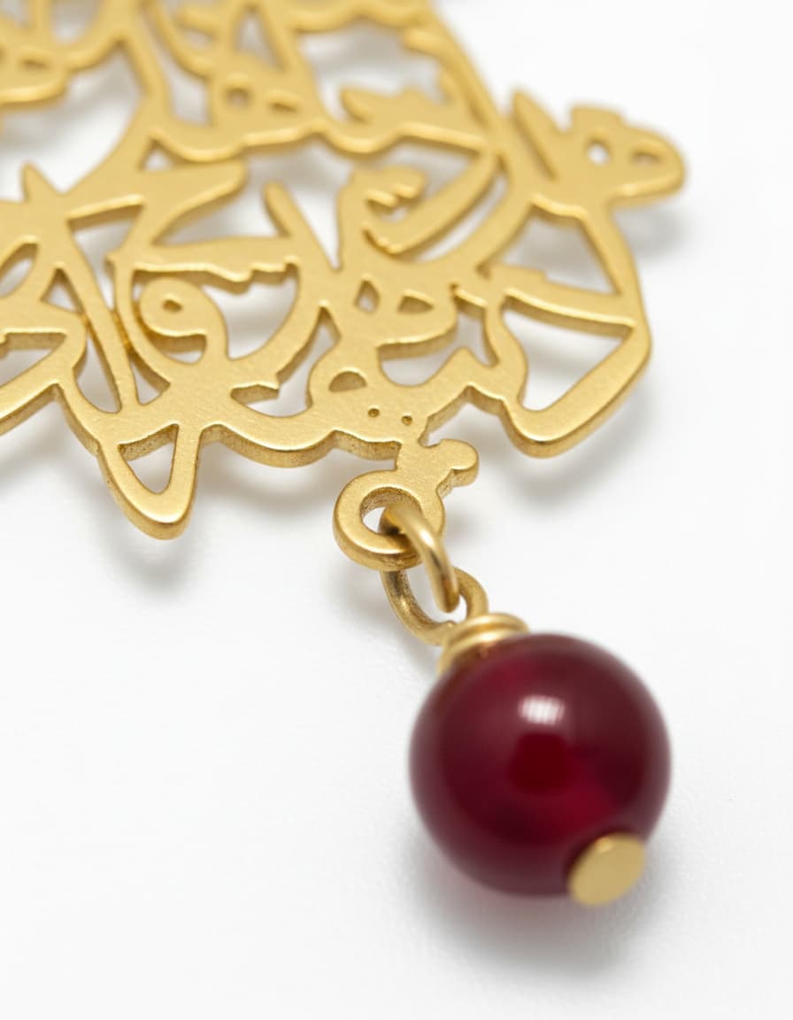 Close-up of the gold-plated Farsi calligraphy script pendant