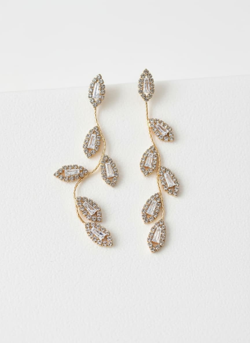 Gold leaf branch earrings with simulated diamonds on white