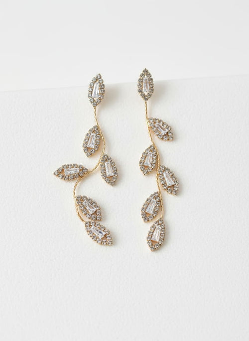 Gold leaf branch earrings with simulated diamonds on white
