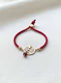 Gold-plated red pomegranate bracelet on white