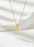 Gold eshgh rectangle pendant necklace on white