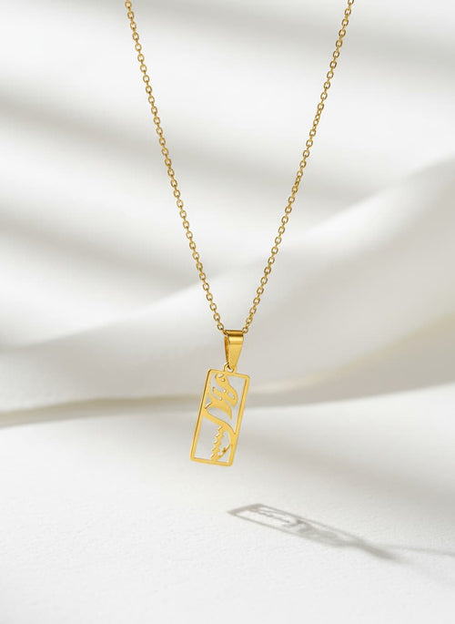 Gold eshgh rectangle pendant necklace on white
