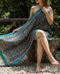 Model wearing a dark navy medallion floral shawl with turquoise border