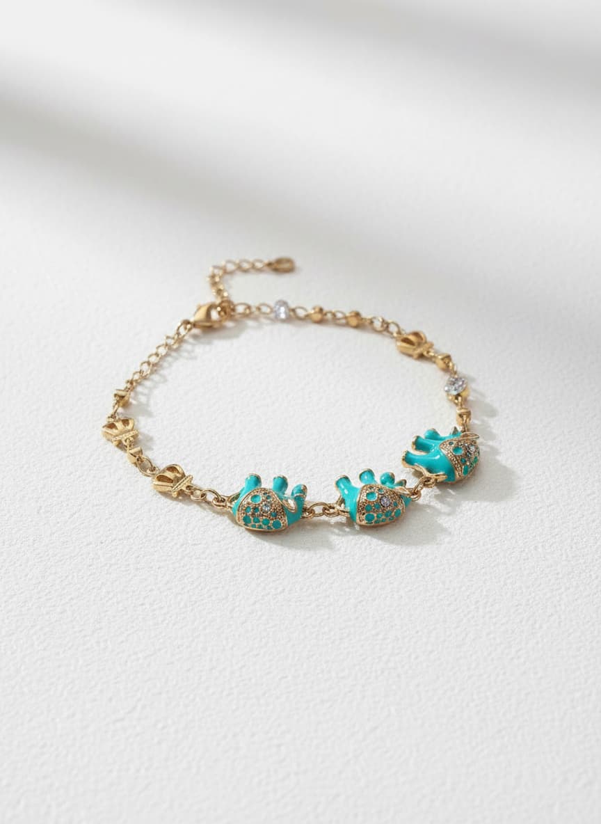 Gold lucky elephant bracelet with turquoise on white