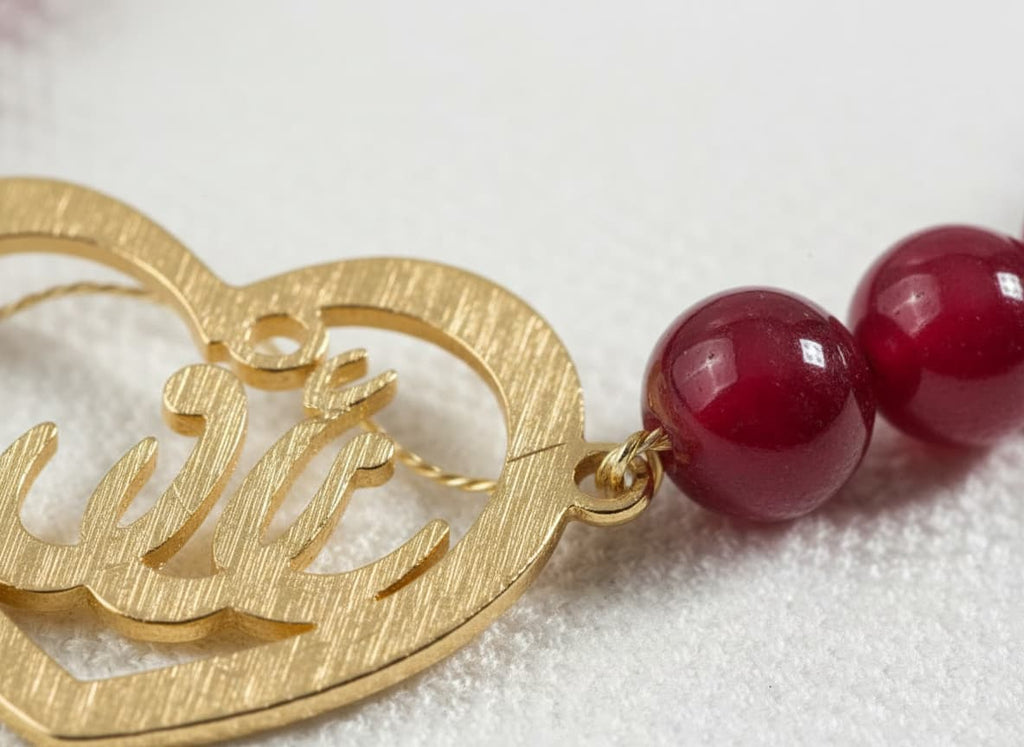 Macro close-up of the gold calligraphy heart pendant