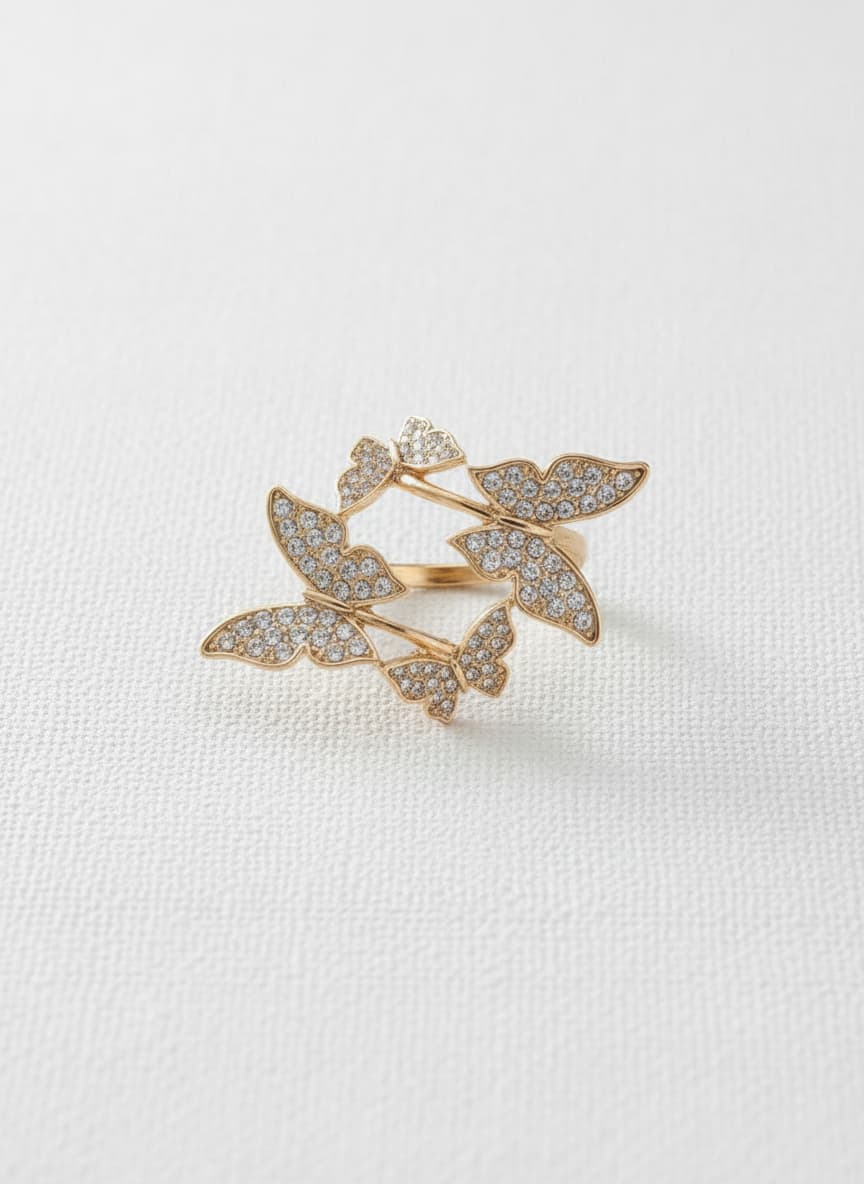 Gold-plated butterfly ring with stones on white