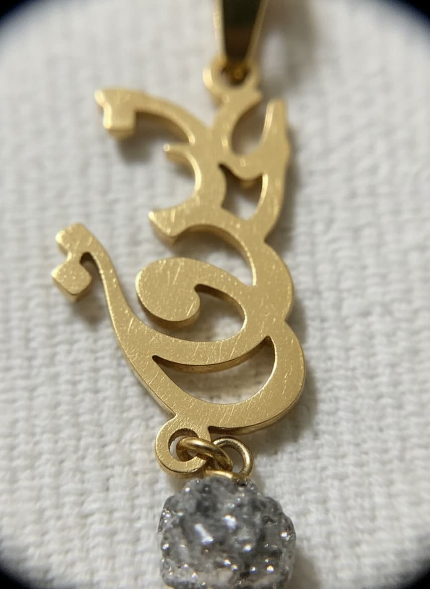 Macro close-up of the calligraphy pendant with clear stone