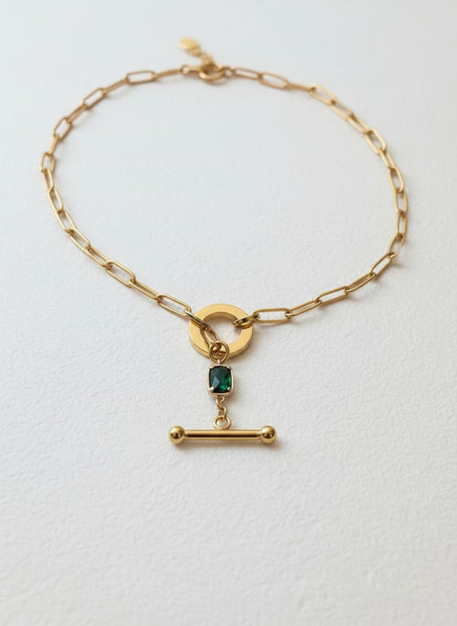 Gold jade toggle necklace on white
