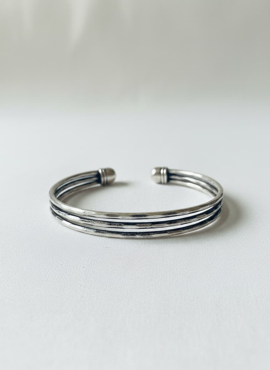 Silver-tone triple-row cuff bangle on white