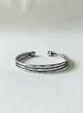 Silver-tone triple-row cuff bangle on white