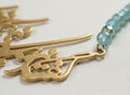 Gold calligraphy necklace with turquoise beads
