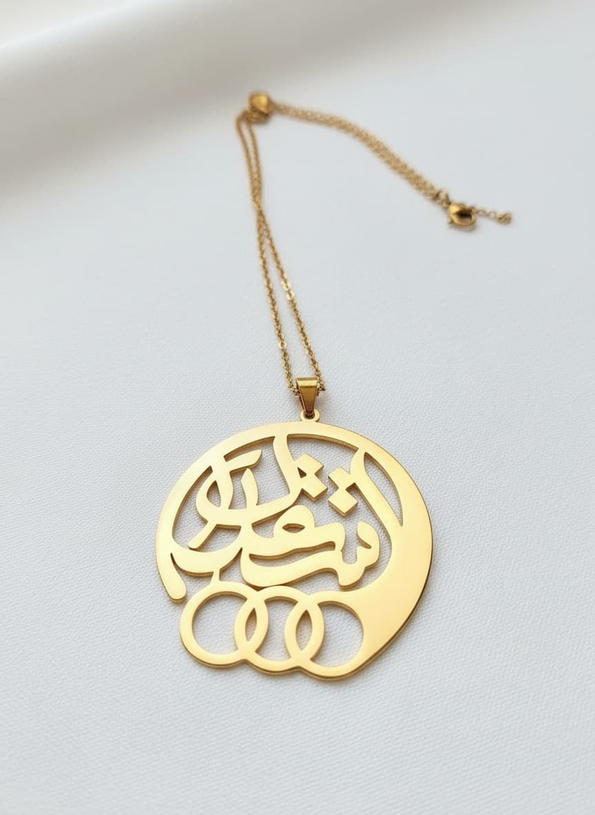Gold esteghlal calligraphy medallion necklace on white