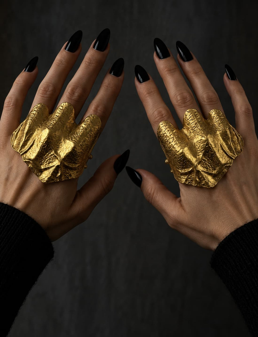 Gold-plated hammered statement ring worn on both hands
