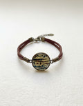 Persian calligraphy leather bracelet with colorful medallion on white