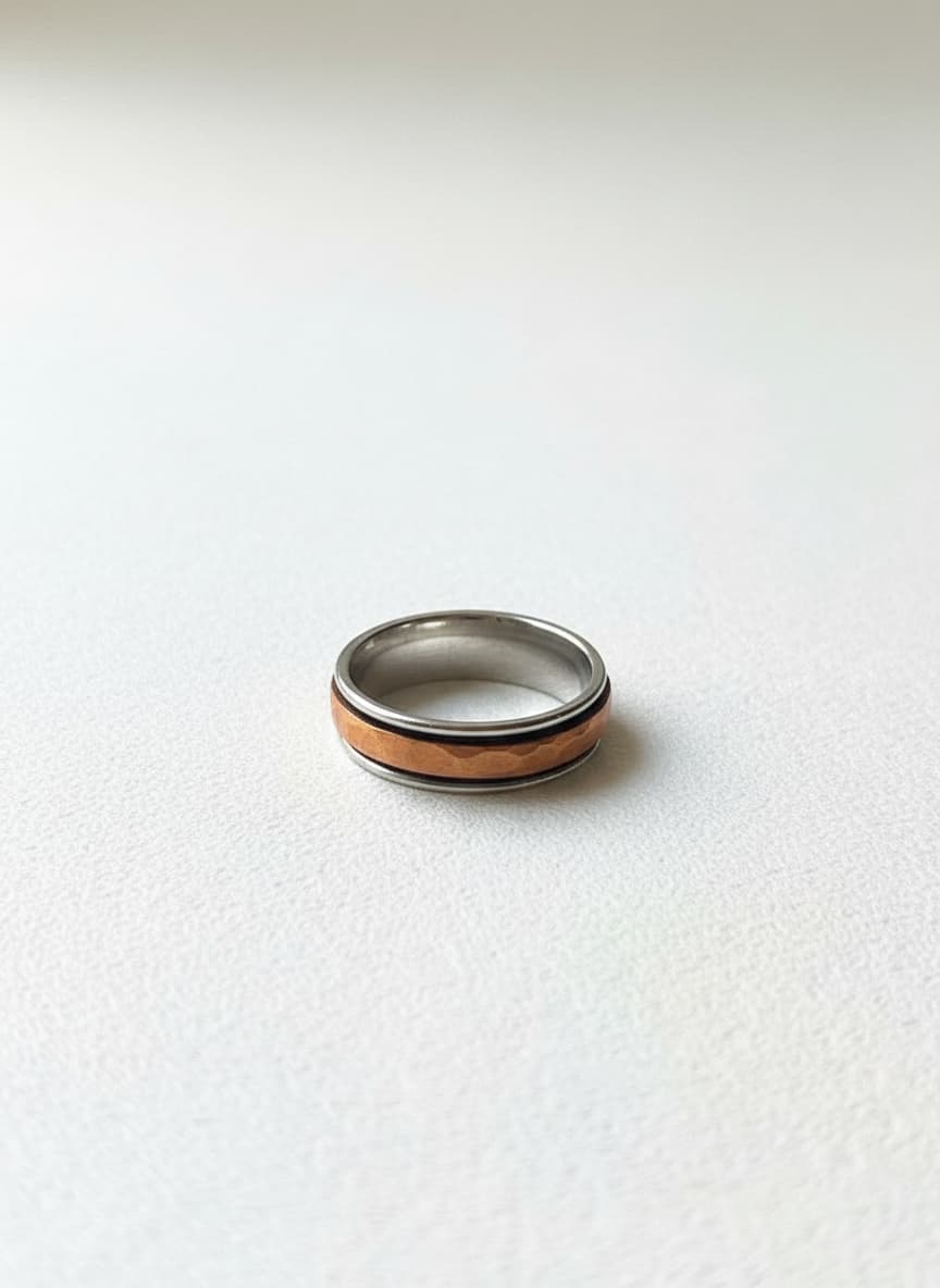 Copper-plated movable ring with brass and copper bands on white