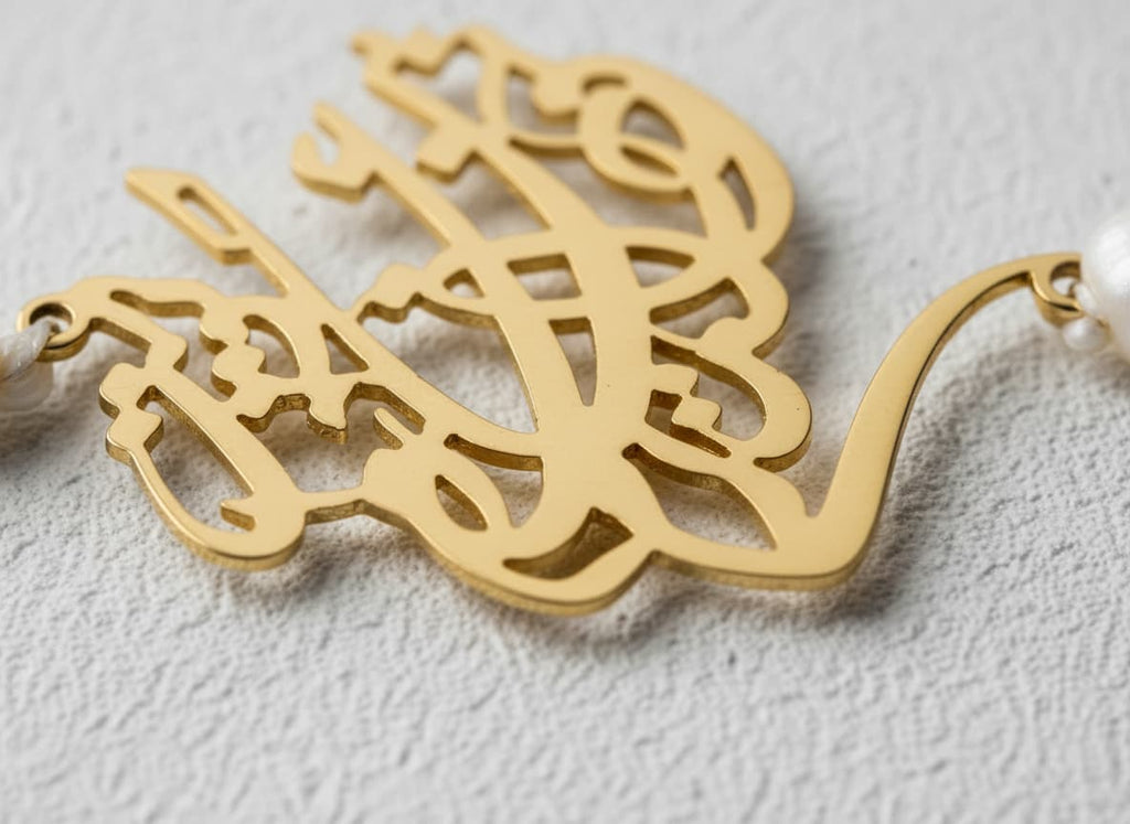 Macro close-up of the gold-plated calligraphy and pearl beads