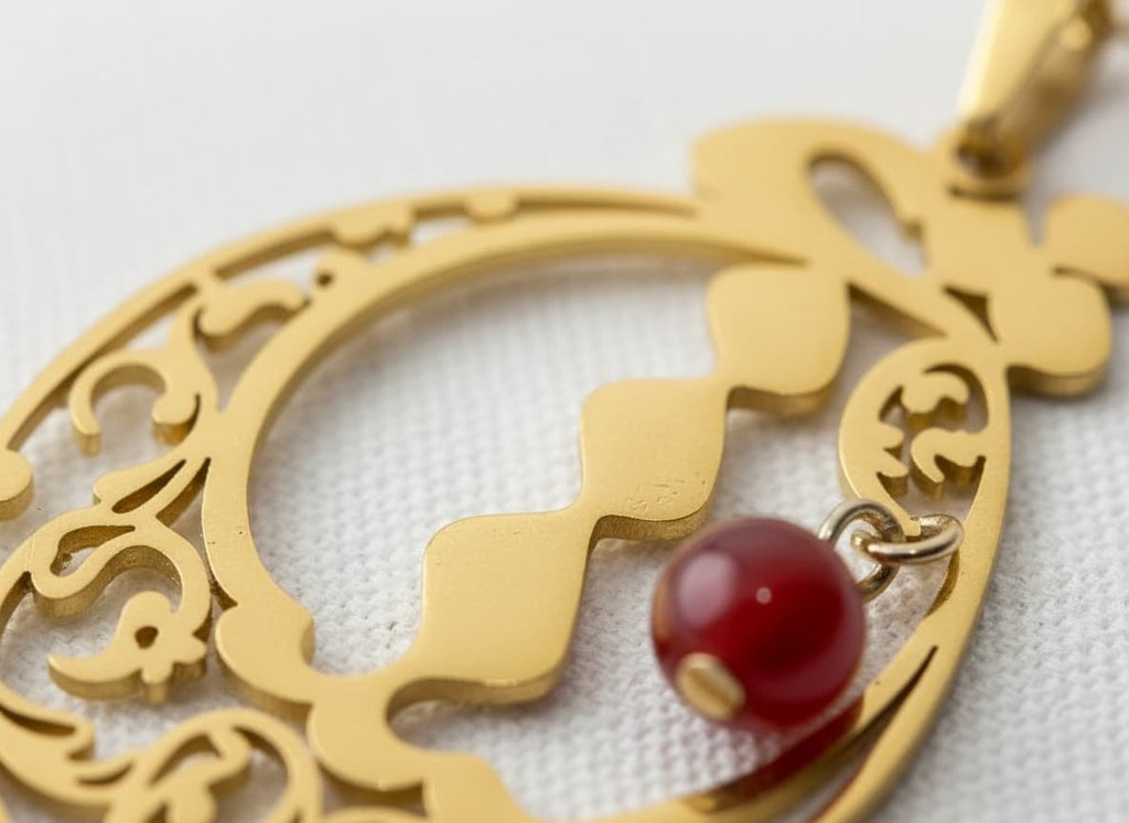 Macro close-up of the calligraphy pendant with red stone