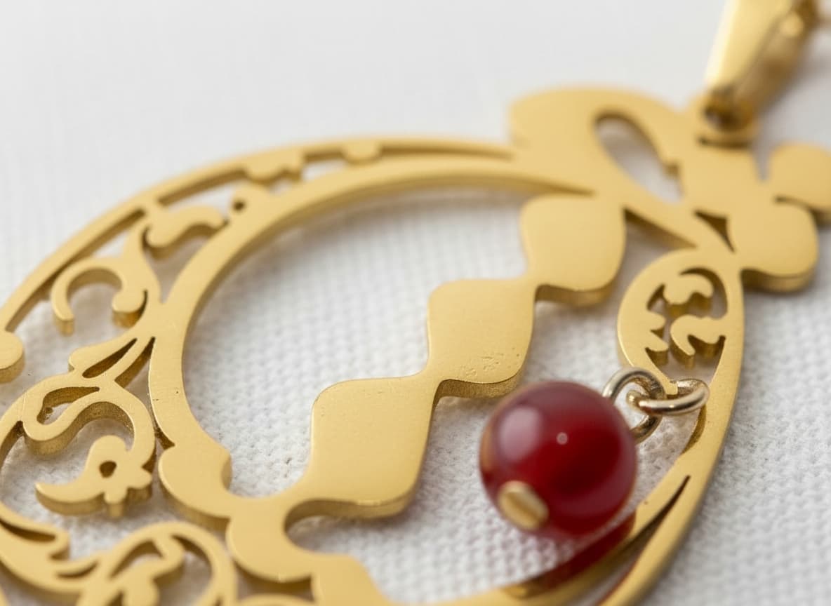 Macro close-up of the calligraphy pendant with red stone