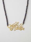 Gold-plated calligraphy center necklace with black Czech glass beads on white