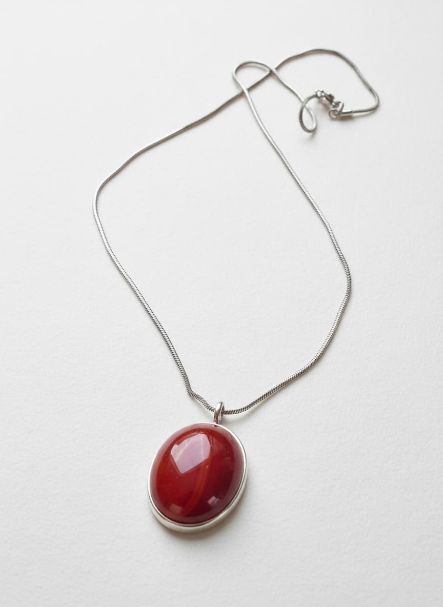 Silver-plated agate pendant necklace on white