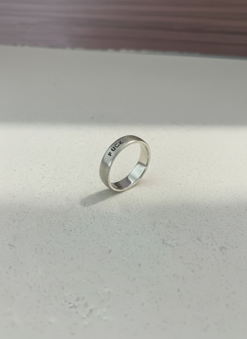 Silver engraved band ring on white background