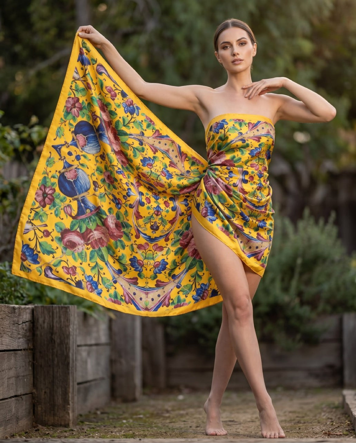 Woman in yellow floral dress holding a scarf