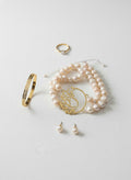 Persian calligraphy bracelet with pearls styled in a flatlay