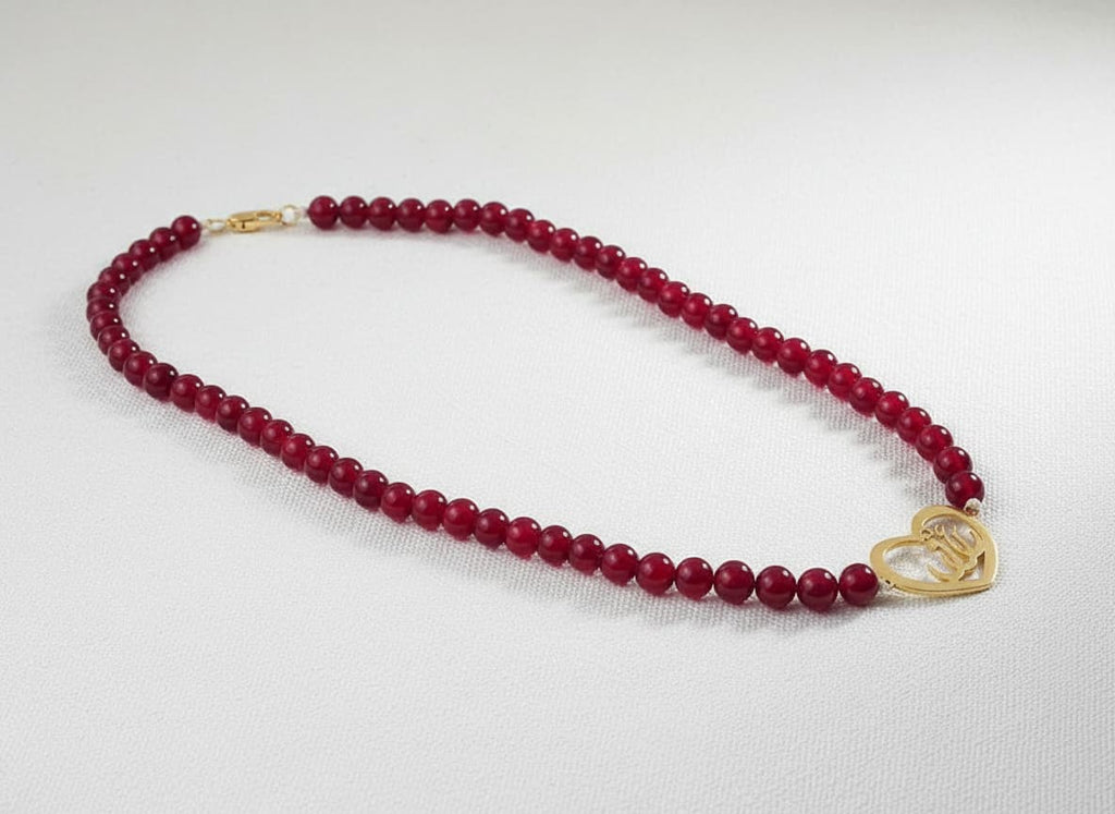 Gold heart calligraphy necklace with red stone beads