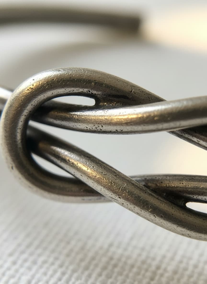 Macro close-up of the knot on the silver-tone bangle
