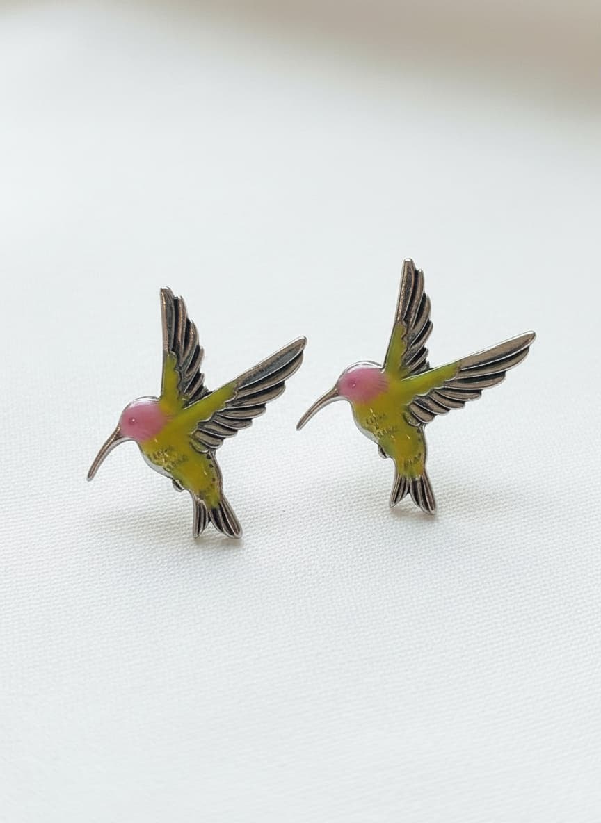 Silver-plated hummingbird stud earrings on white