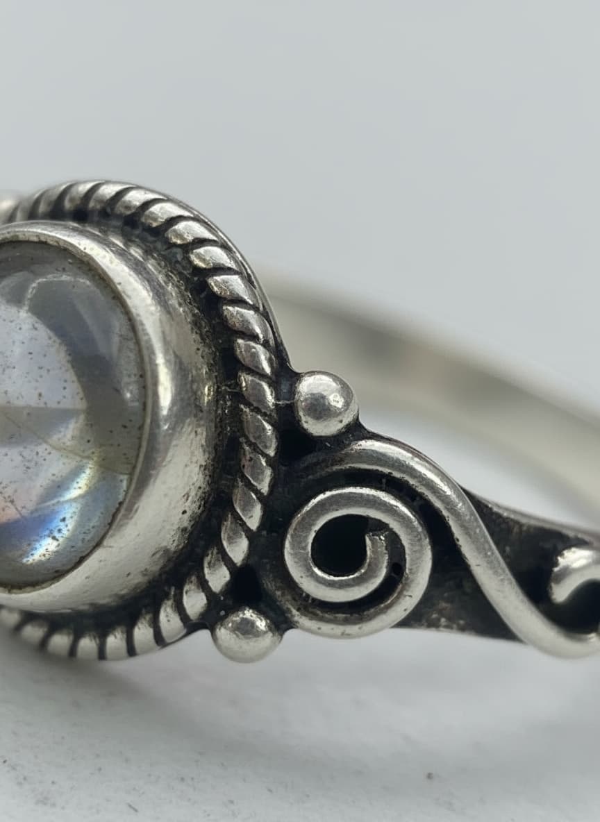 Macro close-up of the moonstone and scrollwork setting