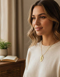 Model wearing the gold-plated shield key pendant necklace