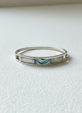 Silver-tone floral shell bangle on white