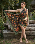 Woman wearing a black shawl with rose and bird prints