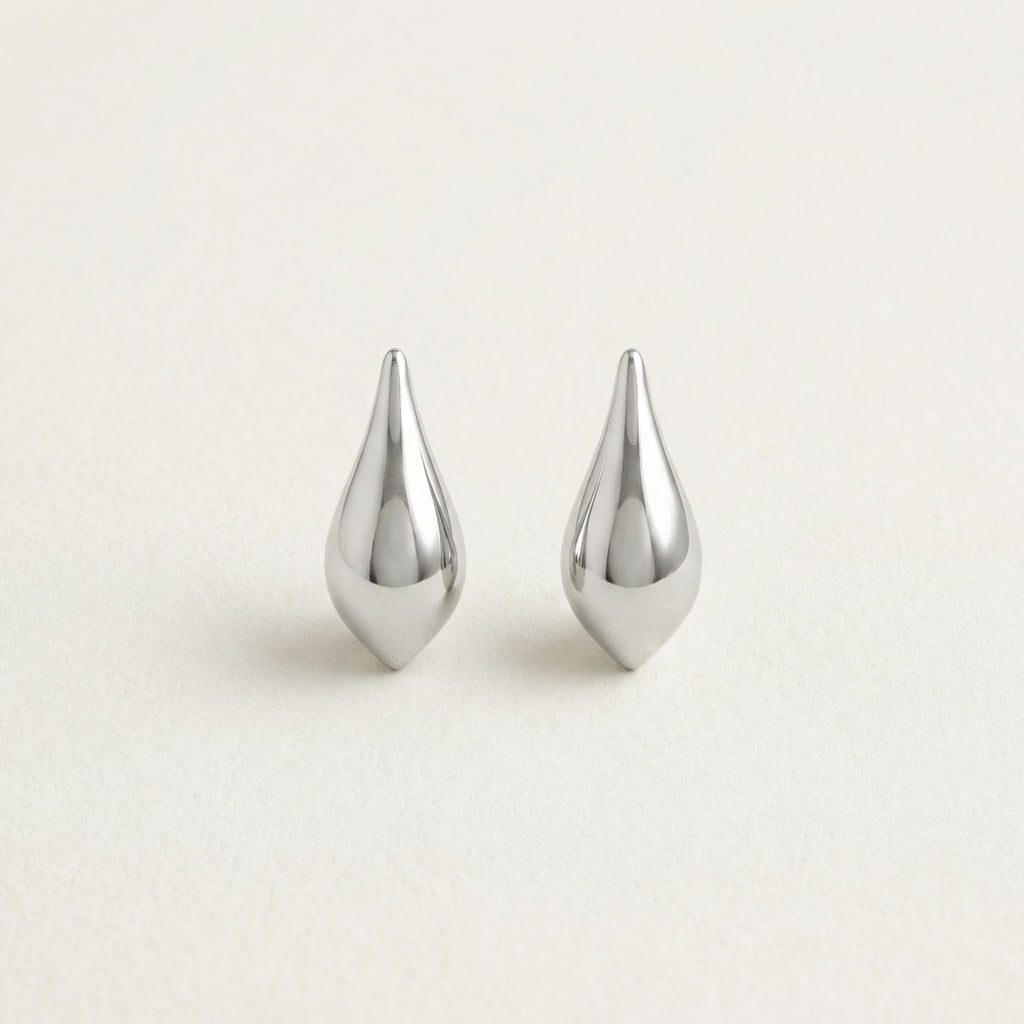 Silver teardrop hanging earrings on white