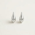 Silver teardrop hanging earrings on white