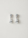 Silver-tone pear drop crystal earrings on white background