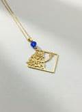 Gold calligraphy necklace with blue stone on white