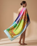 Model wearing a multicolor geometric patchwork shawl