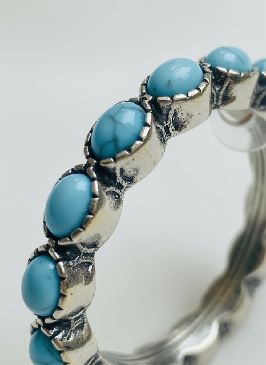 Macro close-up of the turquoise stones on the silver-plated earrings
