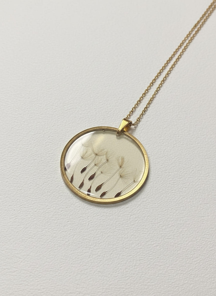 Gold-plated pendant necklace with real pressed dandelion seeds sealed under glass