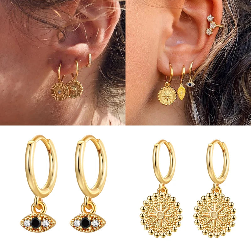 Gold earrings displayed on an ear and arranged below.
