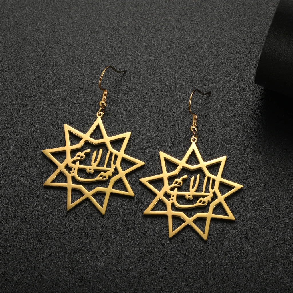 Gold star-shaped earrings with Arabic calligraphy on a black background