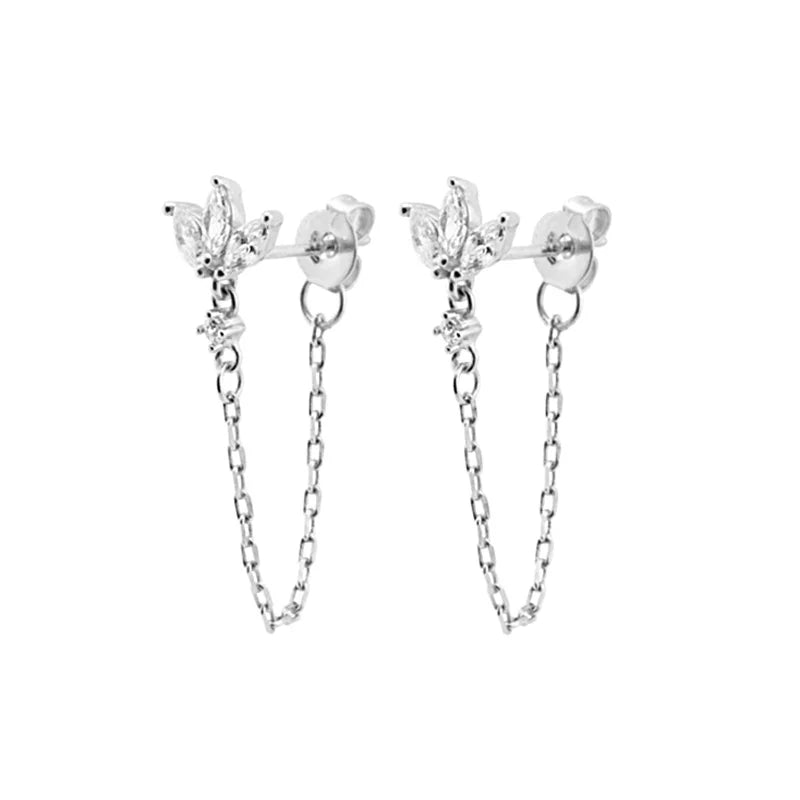 A pair of silver dangle earrings with a small floral stud and a dangling chain, shown on a plain white background.