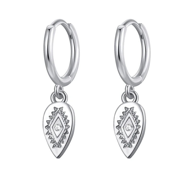Silver hoop earrings with teardrop-shaped charms on a white background